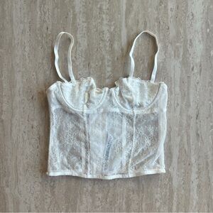 Out from under white lace corset